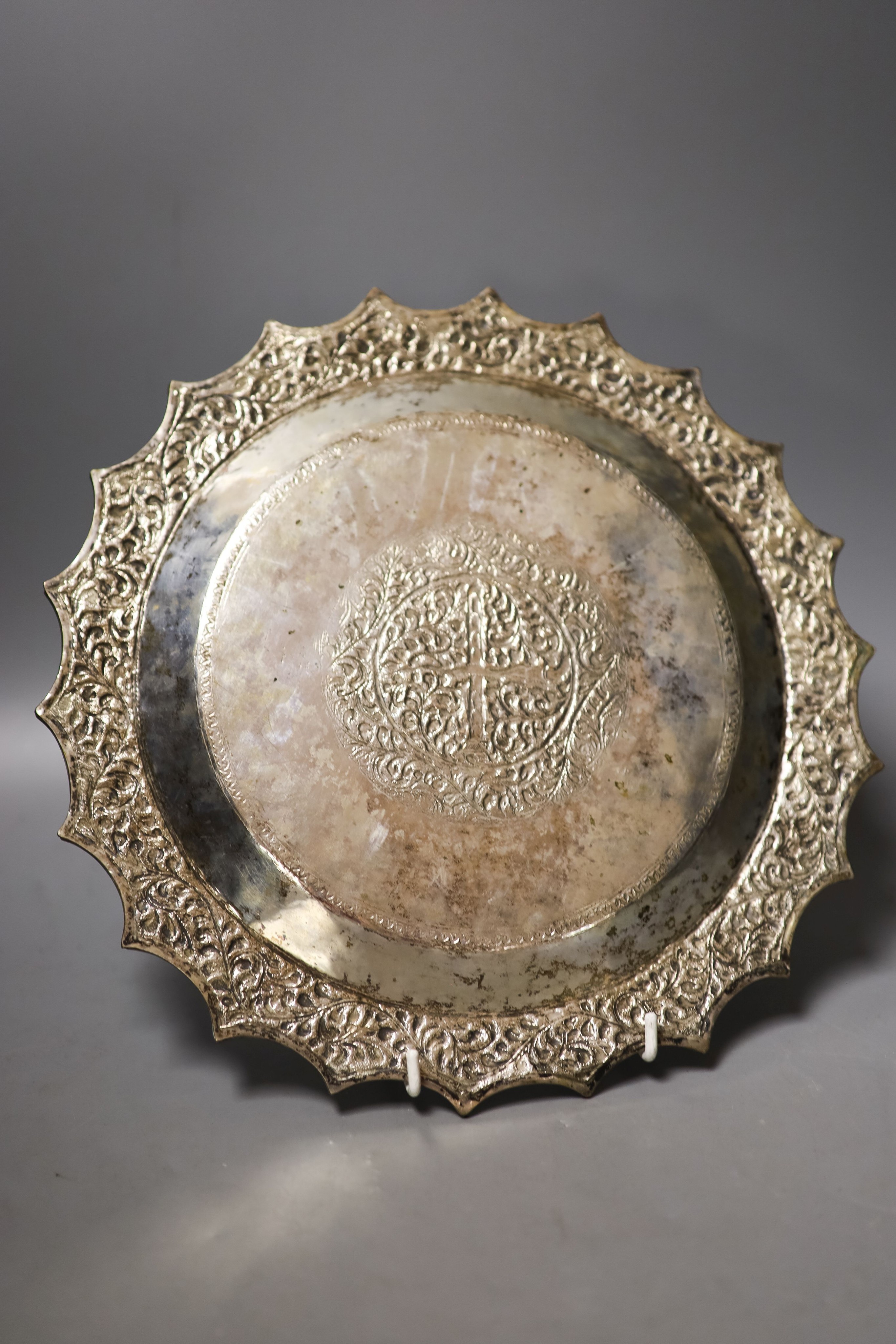 A Thai? white metal salver, with wavy border, 29cm